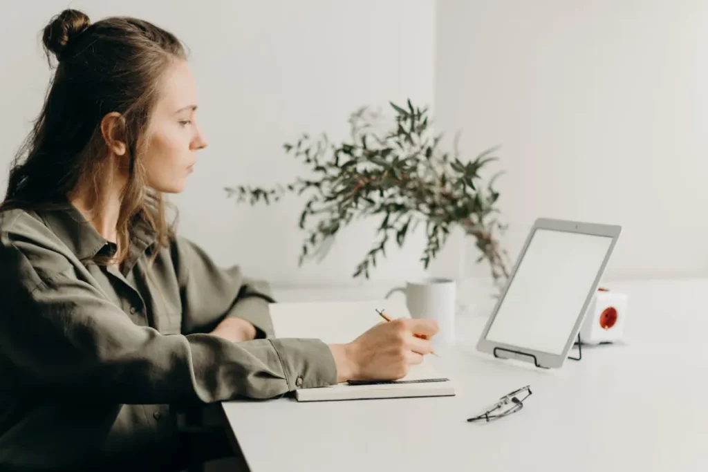 Mulher em escritório de frente para seu laptop